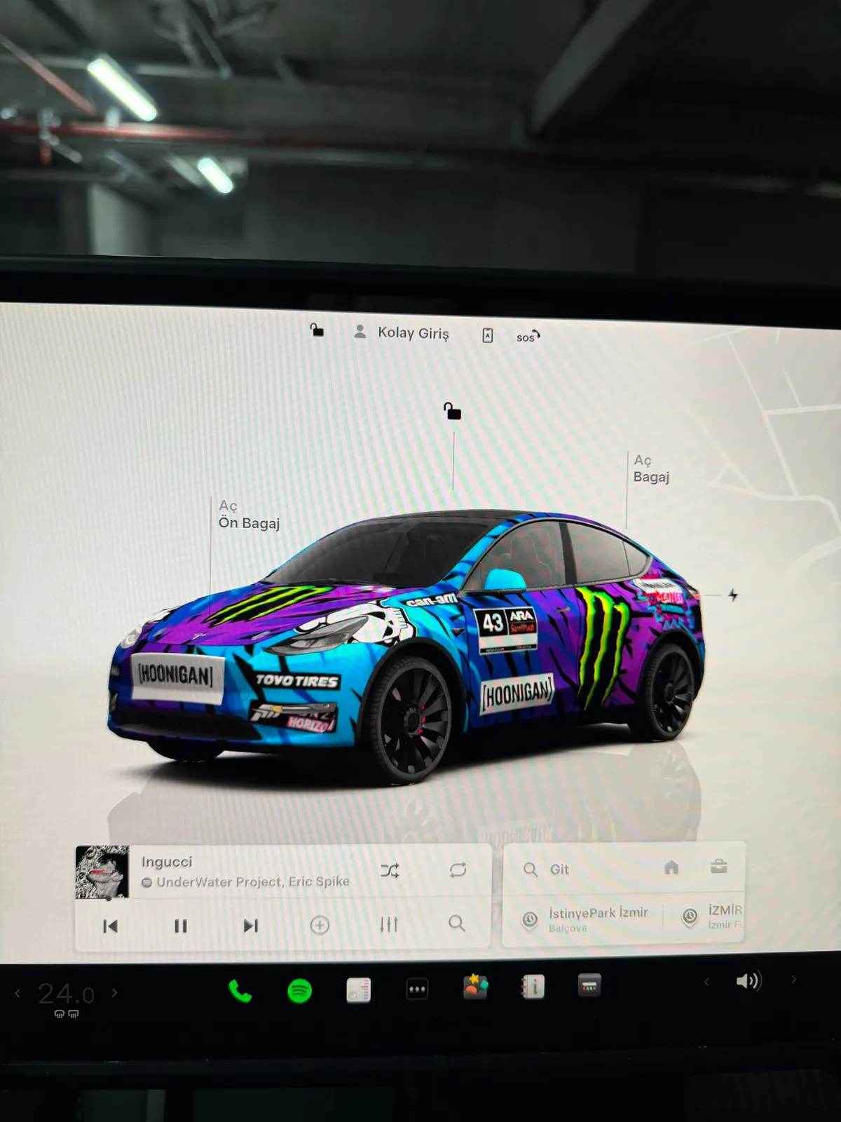 Tesla vehicle screen showing full custom Hoonigan wrap display